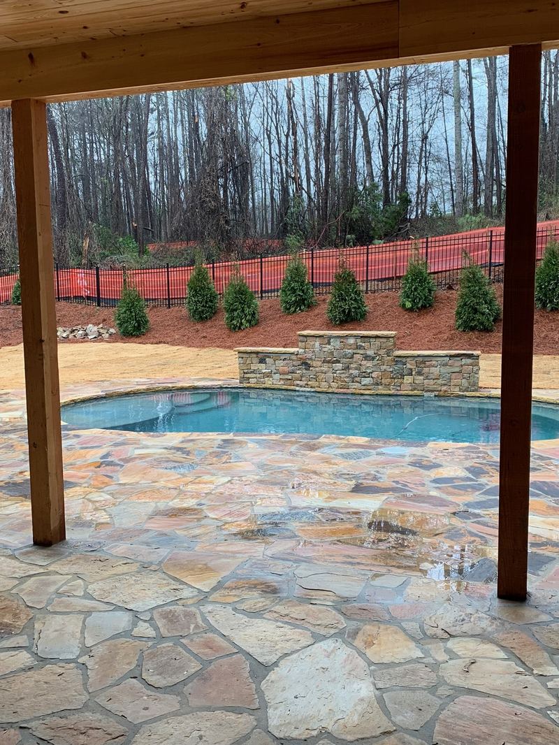 Flagstone patio and pool, framed by timber posts