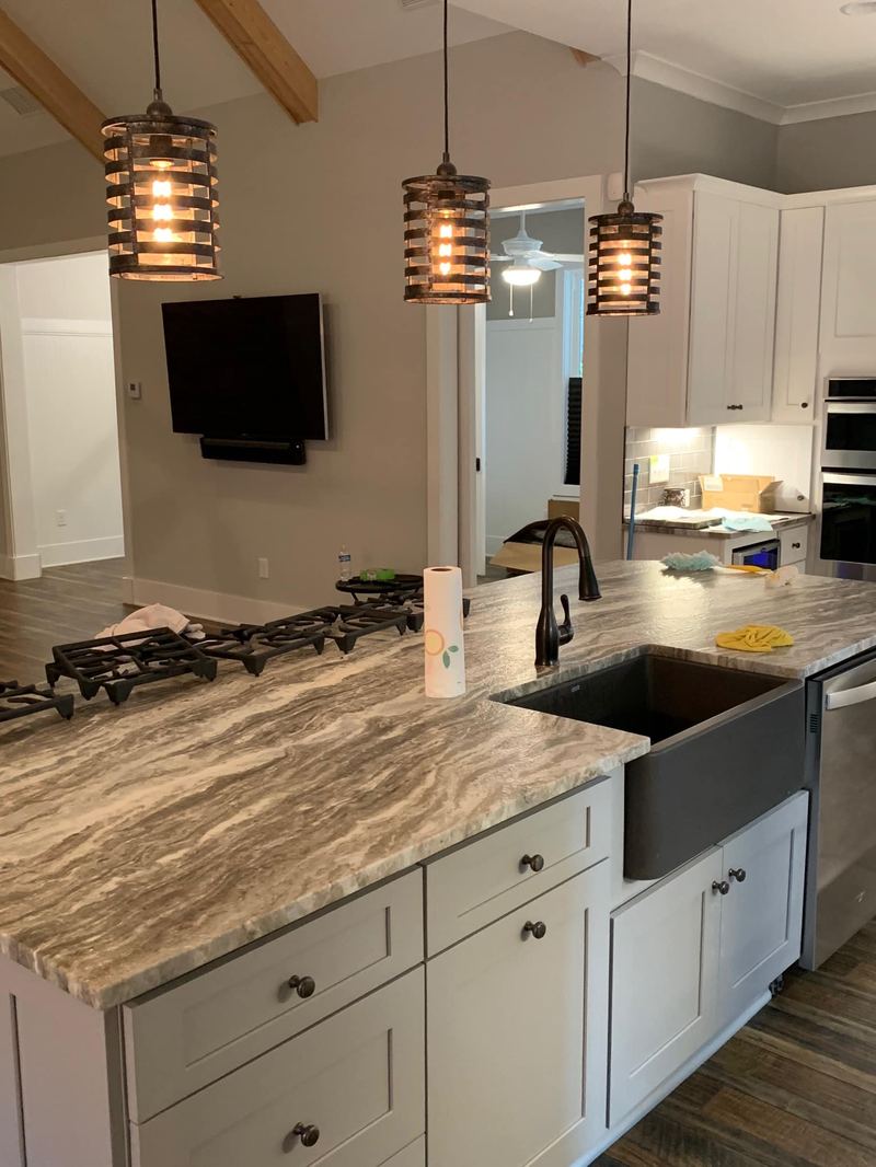 Kitchen with farmhouse sink and quartz island