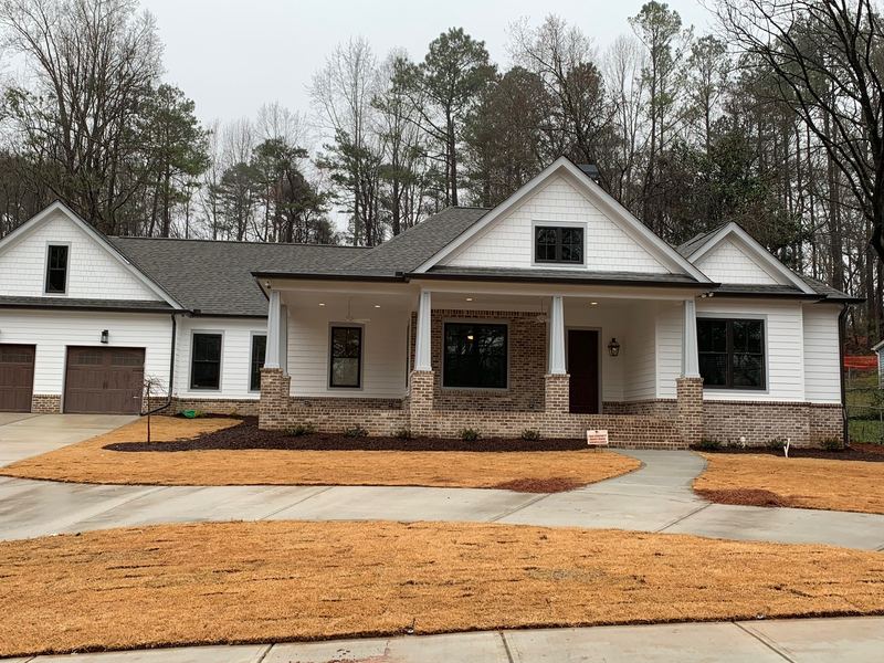 Modern farmhouse with brick water table, new construction